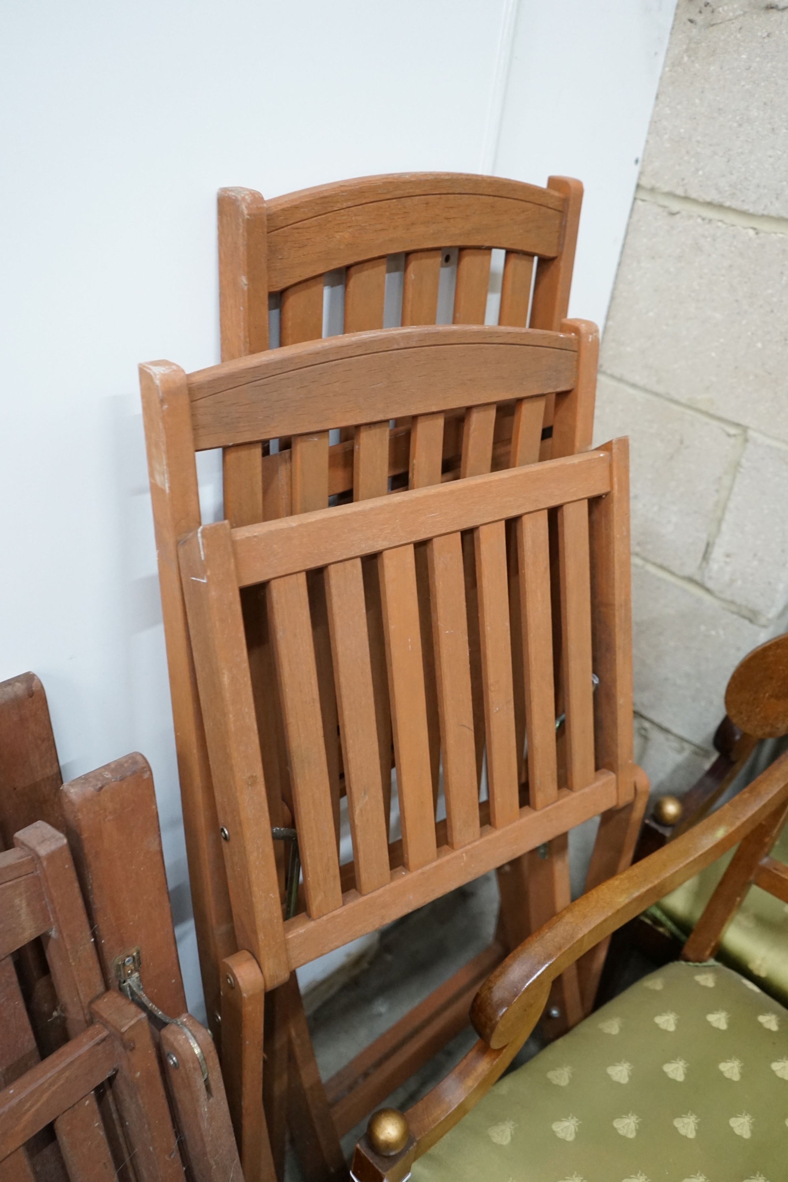 Five assorted teak folding garden chairs